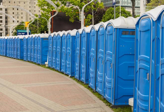 a line of brightly-colored portable restrooms, perfect for outdoor festivals and concerts in Clarkston, GA